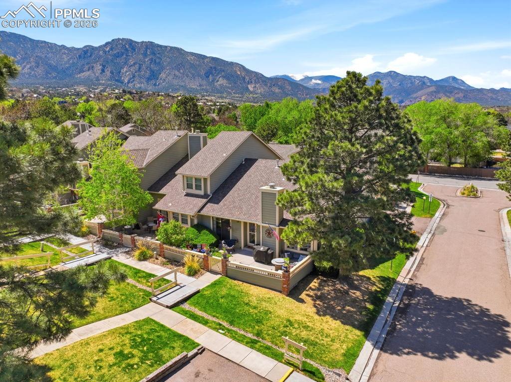 Image 8 of 41: Exterior perspective showcasing multiple gabled roofs of other townhomes, l
