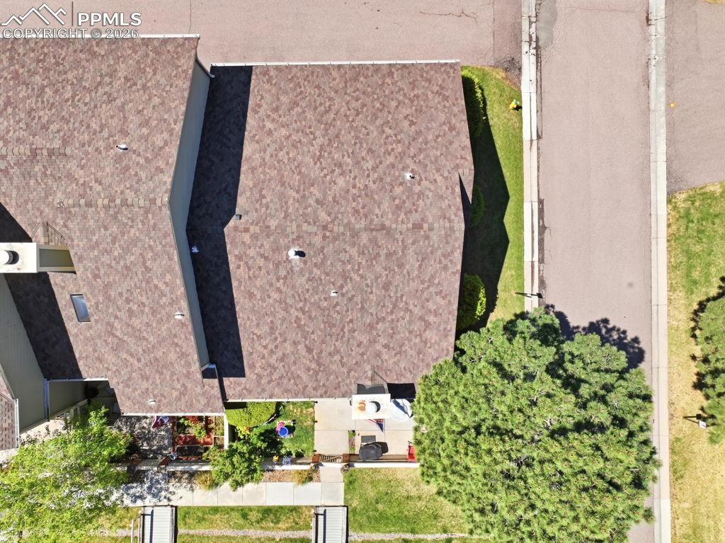 Image 9 of 41: Brown shingled roofline on a single-story residence