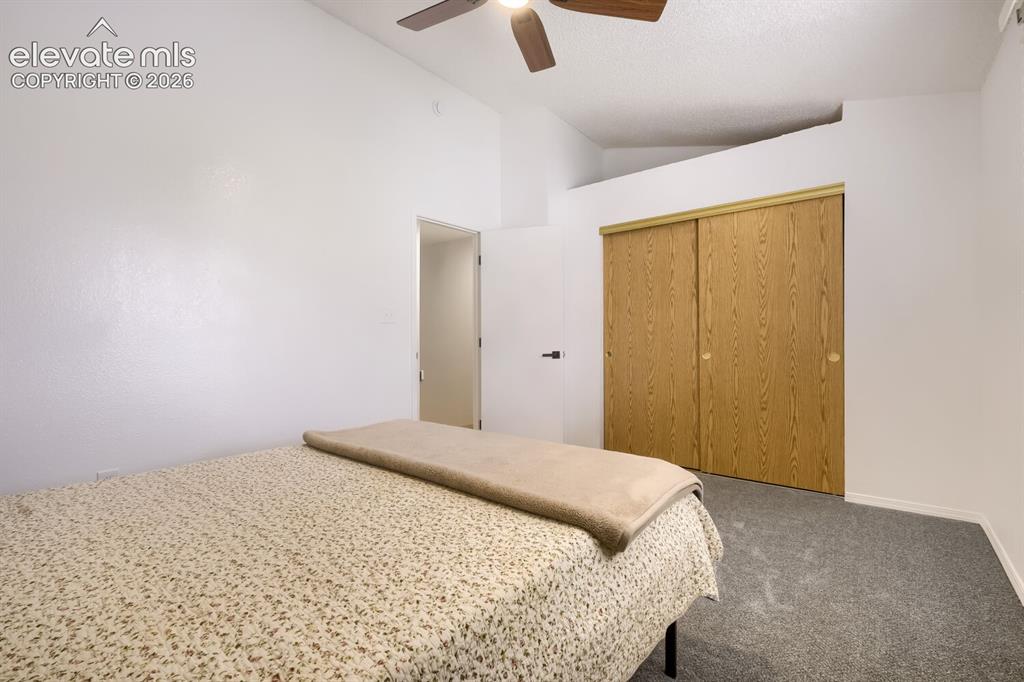 Image 16 of 25: Room featuring vaulted ceilings, a ceiling fan with integrated lighting, wa