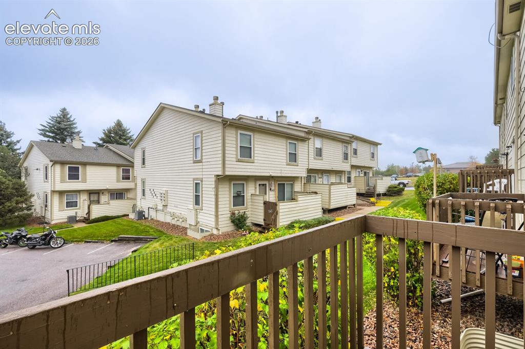 Image 20 of 25: Multi-level residential exterior featuring horizontal siding and private wo