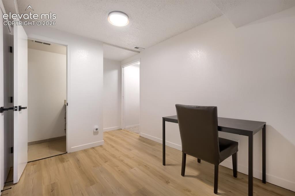 Image 7 of 25: Interior space featuring neutral wall tones, light wood-finish flooring, ce