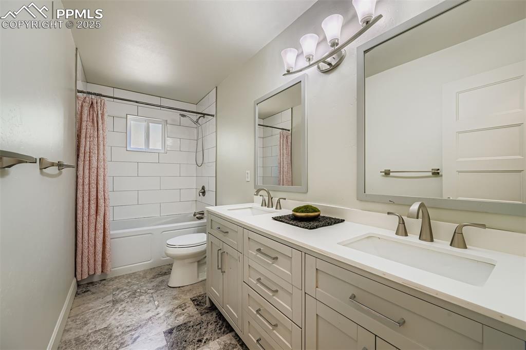 Image 26 of 37: Updated bathroom w/ double vanity and plenty of spacious storage.