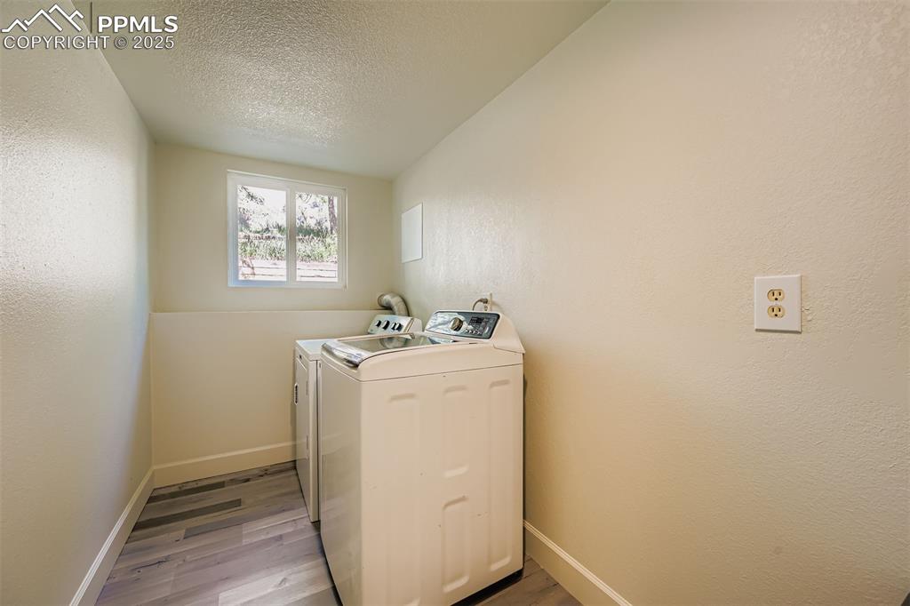 Image 27 of 37: Spacious laundry room with room for shelves, cabinets and laundry hampers..