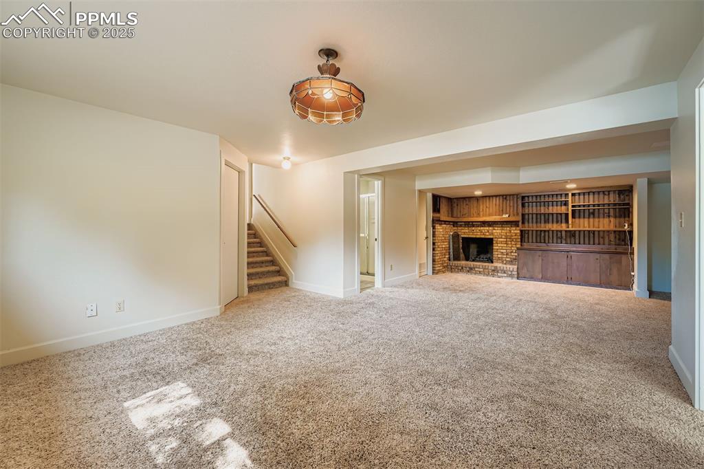 Image 28 of 37: Garden Level Family Room w/ 3/4 bath; fireplace; builtins; office niche; sp