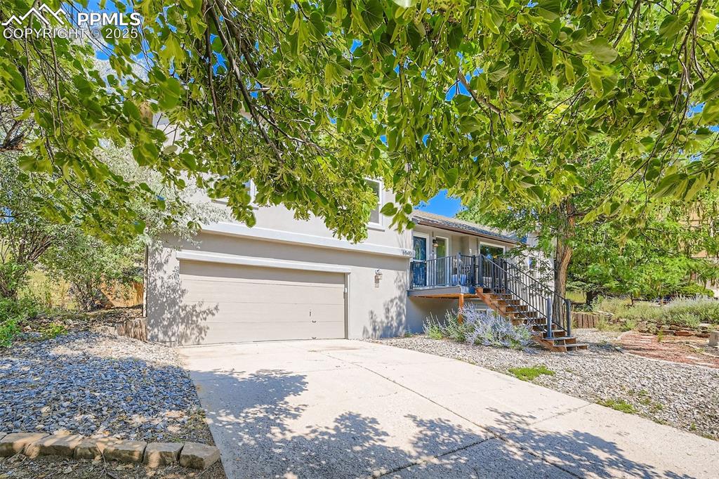 Image 3 of 37: Zeroscaped, stucco, front appeal... shaded oasis!