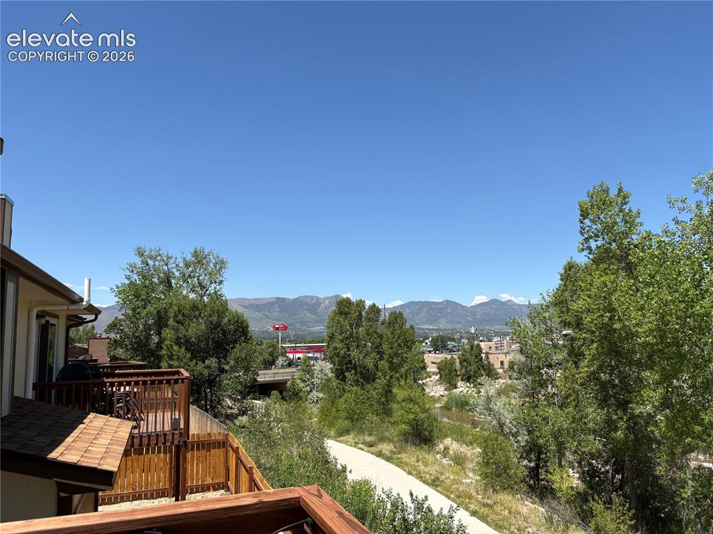Image 10 of 11: Multi-level wood deck featuring a natural wood finish, bordered by a wood p