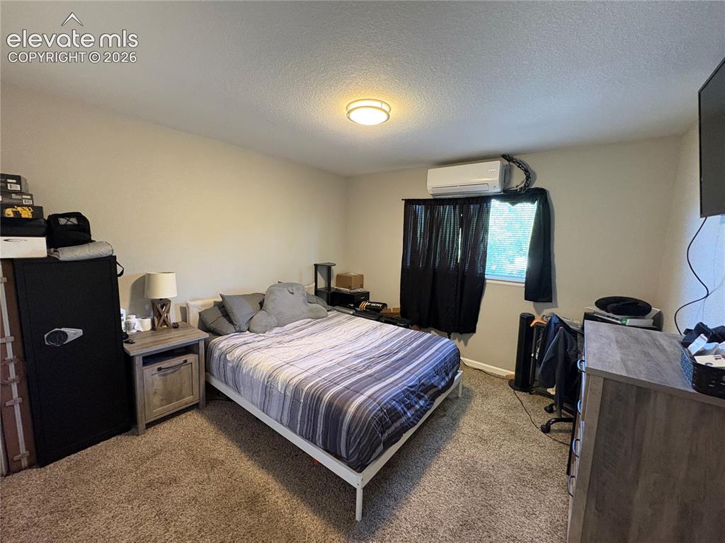 Image 6 of 11: Bedroom featuring neutral-toned walls and carpeted flooring