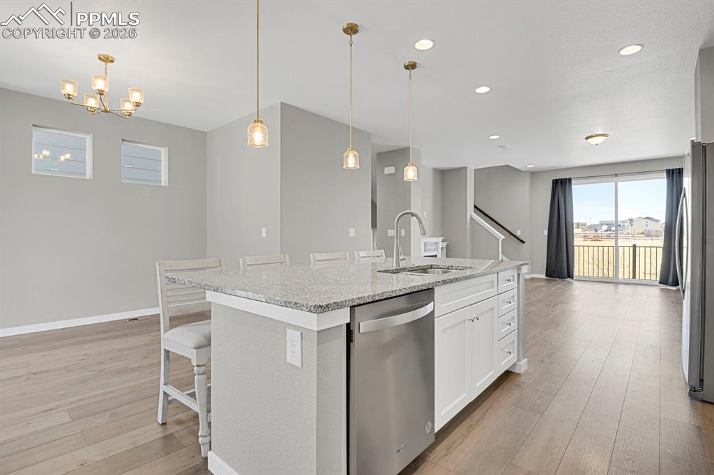 Image 13 of 40: Kitchen looking into the dining area and living room