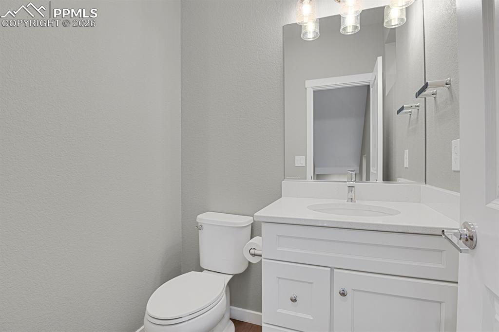 Image 15 of 40: Bathroom with vanity and a textured wall