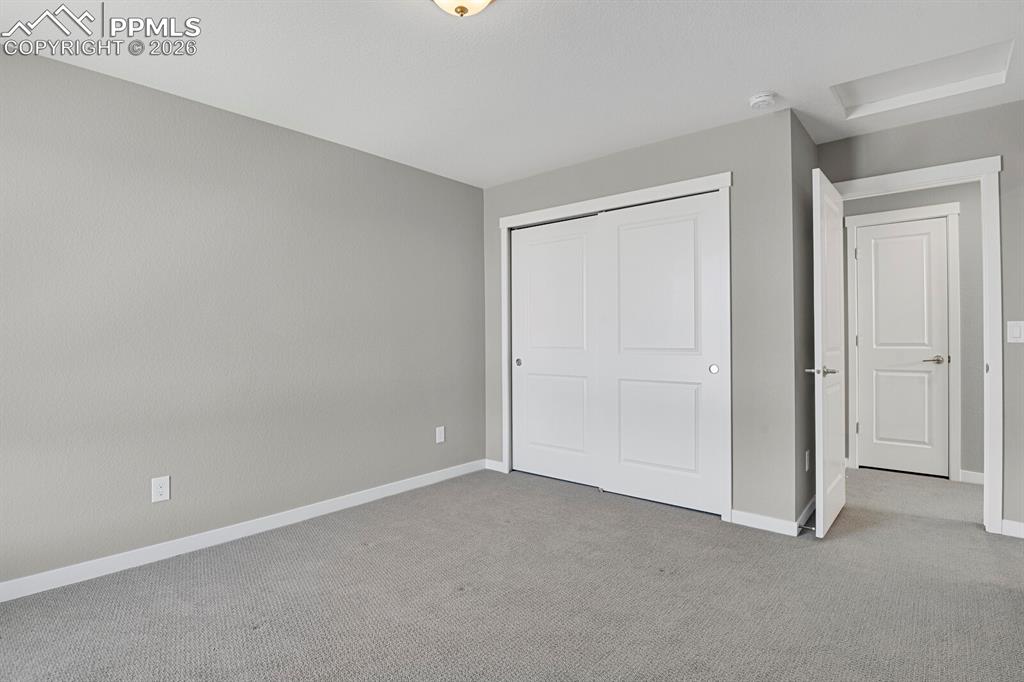 Image 23 of 40: Second bedroom on upper level with en suite bathroom
