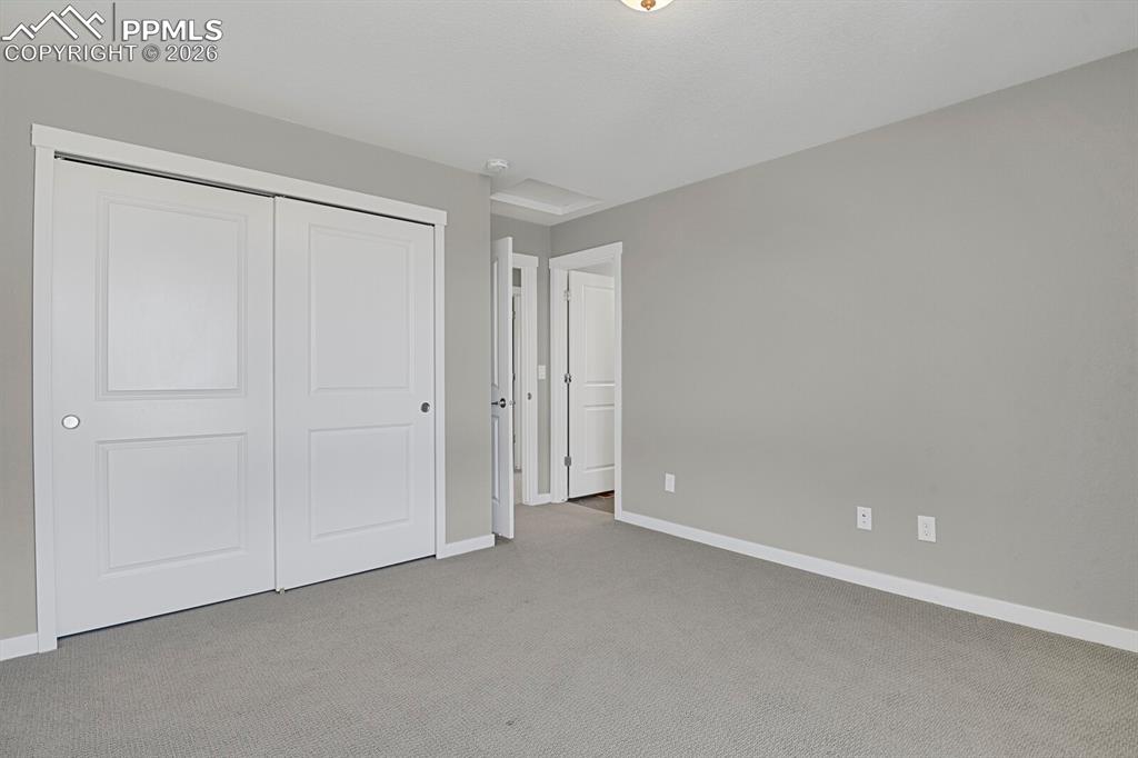 Image 24 of 40: Second bedroom on upper level with ensuite bathroom
