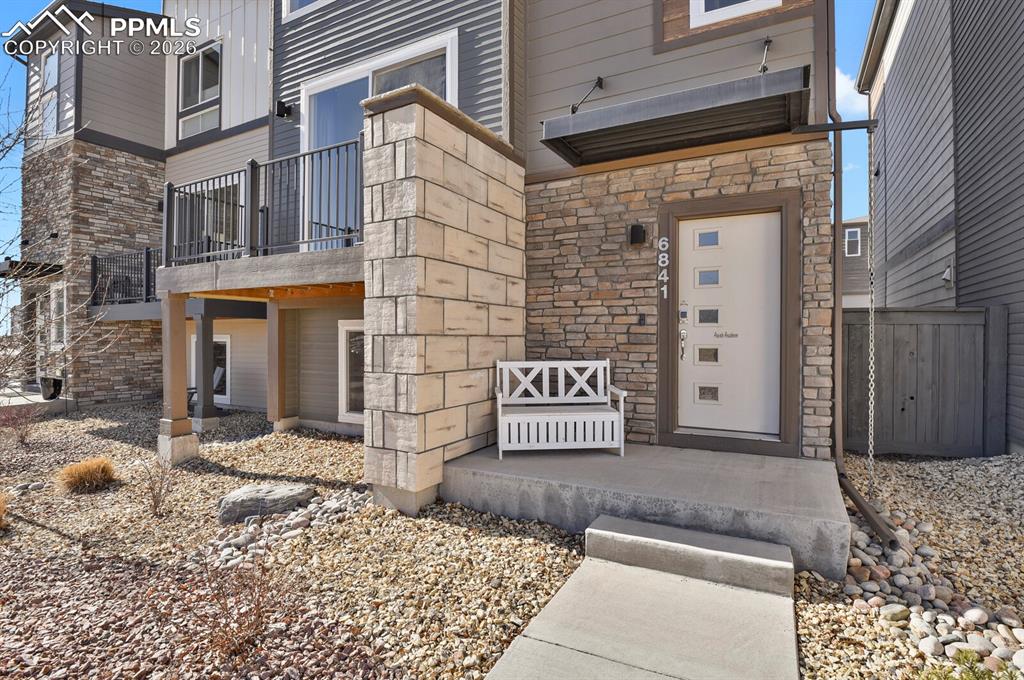 Image 3 of 40: View of exterior entry featuring stone siding