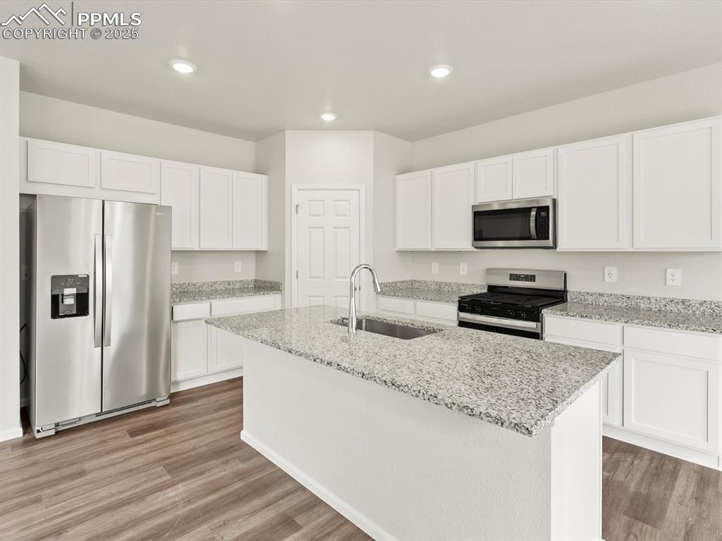 Image 2 of 23: Kitchen with appliances with stainless steel finishes, recessed lighting, a