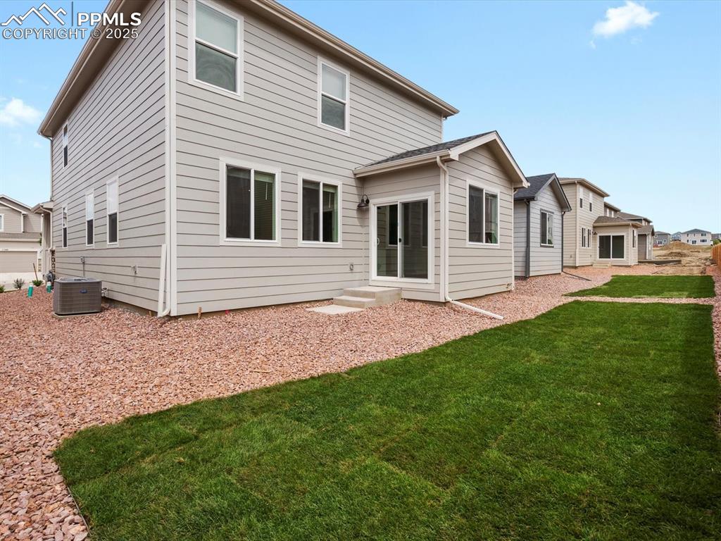 Image 21 of 23: Rear view of property with a yard