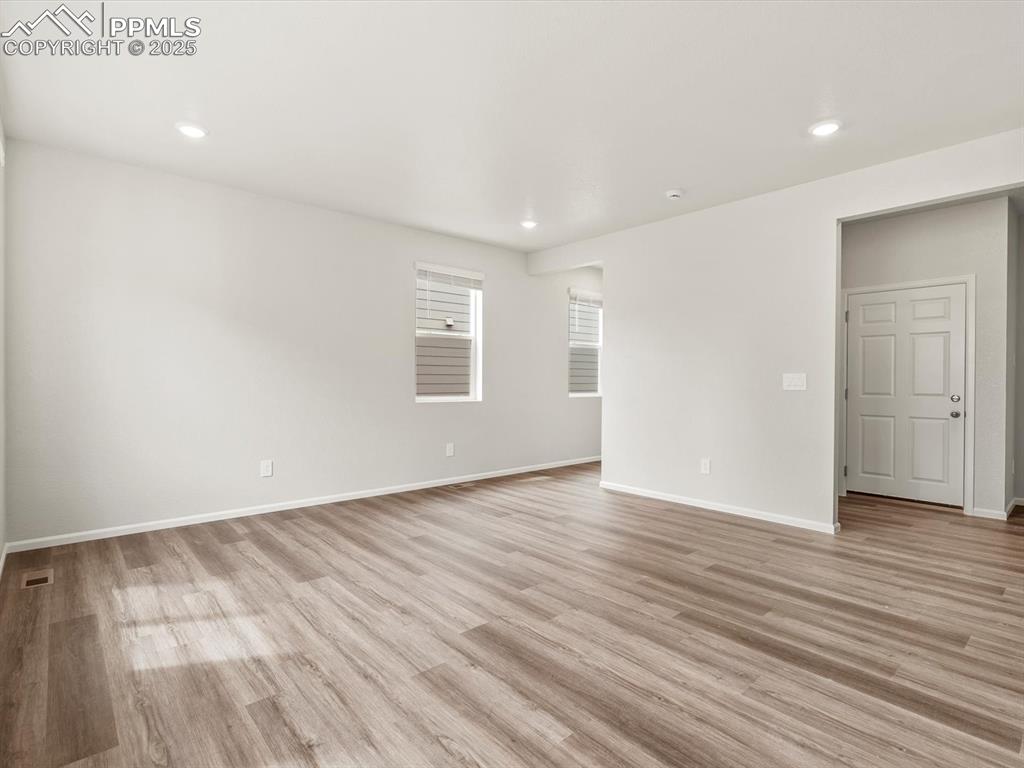 Image 8 of 23: Unfurnished room with light wood-style floors and recessed lighting