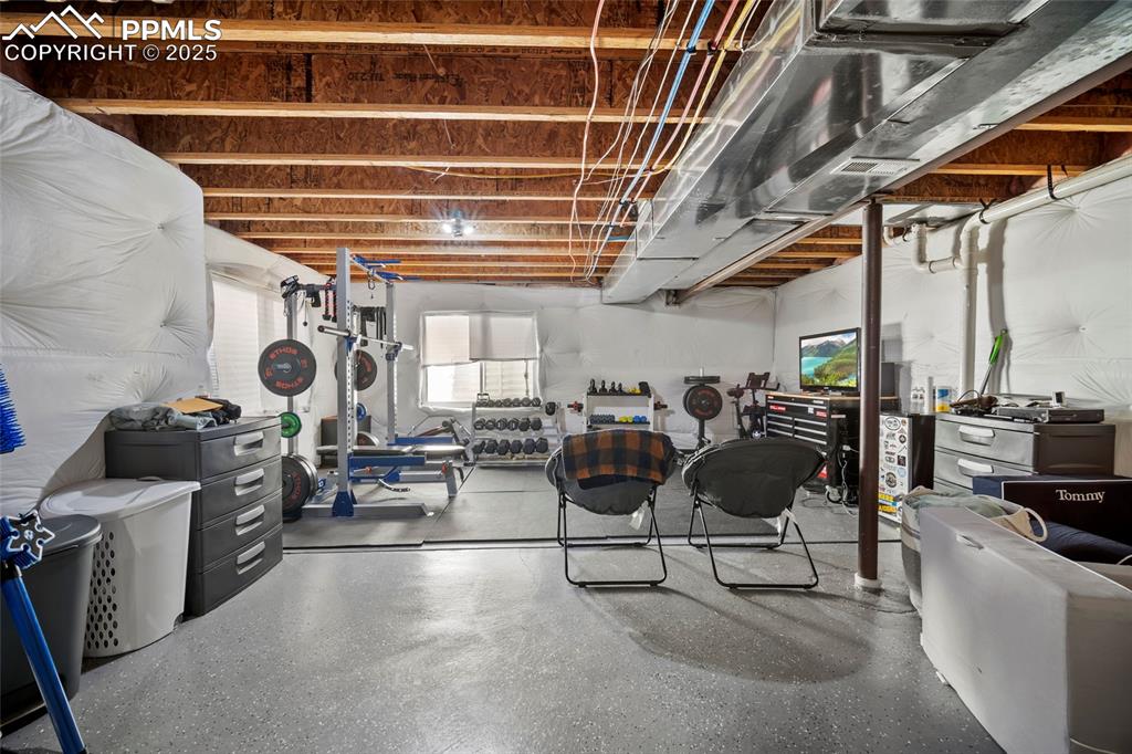 Image 20 of 37: Basement level-- currently used as gym, living room and play area