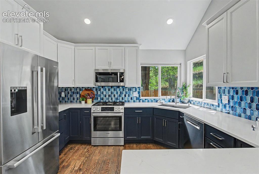 Image 13 of 50: Updated kitchen with abundant counter and cabinet
space; motion sensor fau
