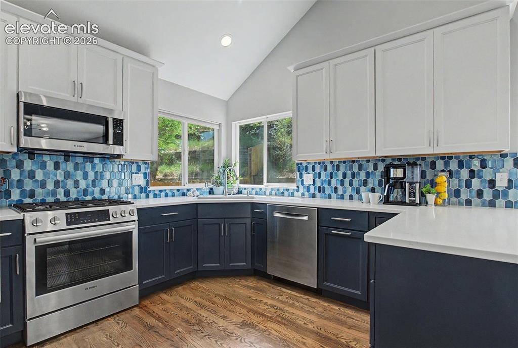 Image 14 of 50: Gorgeous backsplash, new cabinets, new counters
and Bosch appliances