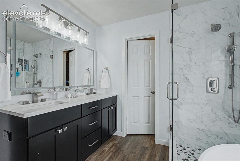 Image 23 of 50: Remodeled spa inspired bathroom with double
vanity and large walk-in close