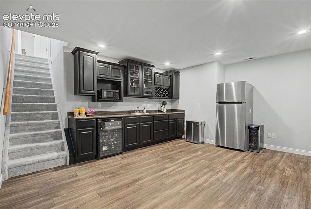 Image 30 of 50: The basement offers a family room and wet bar