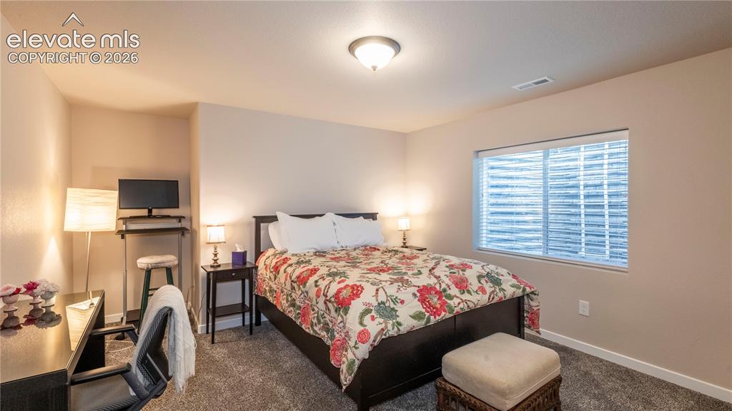 Image 17 of 32: Spacious bedroom with sitting or study area