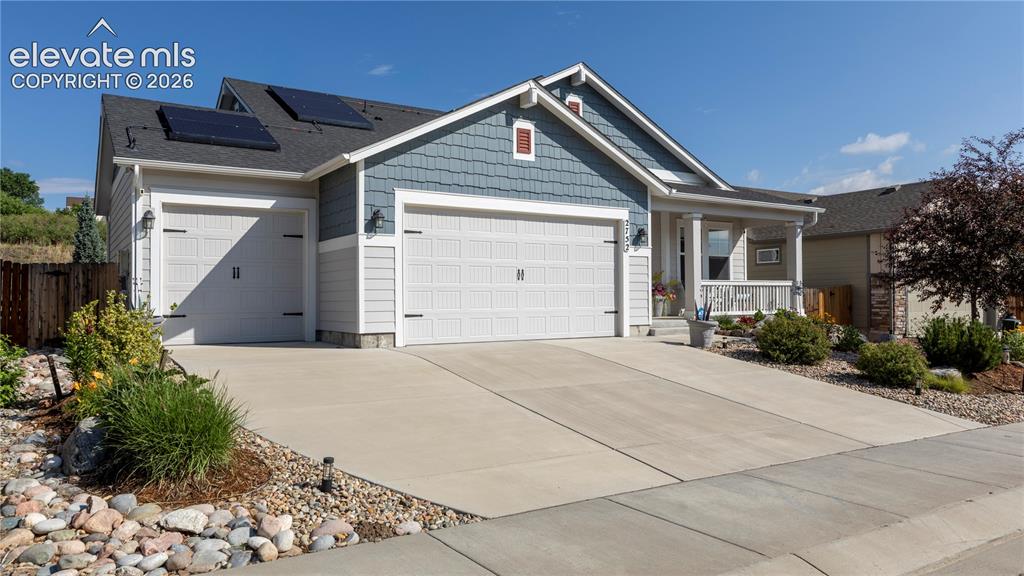 Image 32 of 32: 3 car garage with parking areas