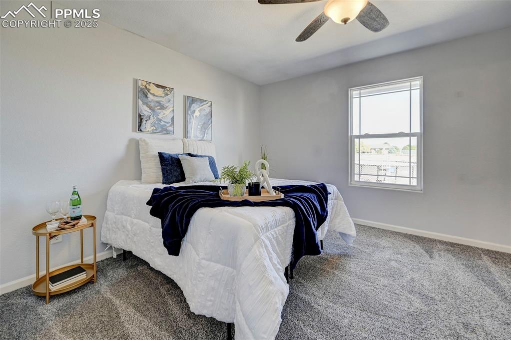 Image 14 of 37: Bedroom with a ceiling fan, baseboards, and carpet floors