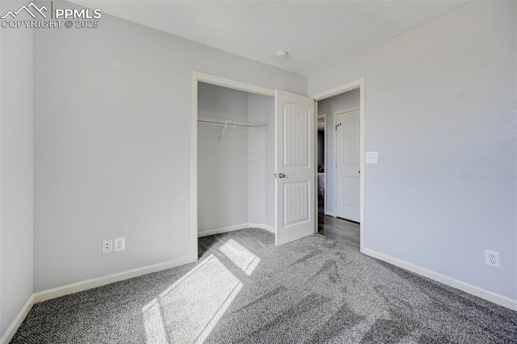 Image 20 of 37: Unfurnished bedroom featuring a closet, carpet flooring, and baseboards