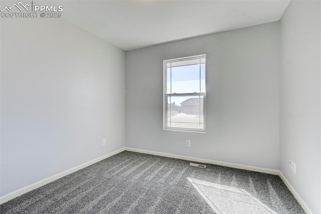 Image 22 of 37: Carpeted empty room featuring visible vents and baseboards