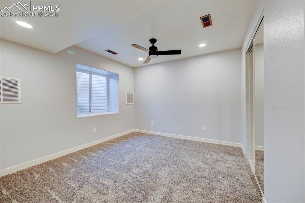 Image 27 of 37: Unfurnished room with carpet, a ceiling fan, and visible vents