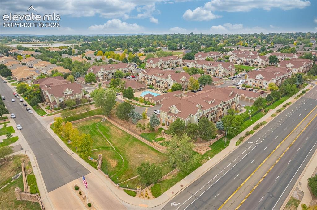 Image 23 of 27: Mixed-material facades, multi-story residences, and a community pool