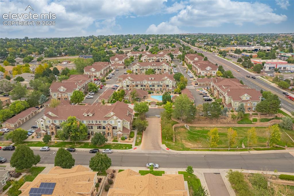 Image 24 of 27: Community featuring multiple residential structures, a central swimming poo