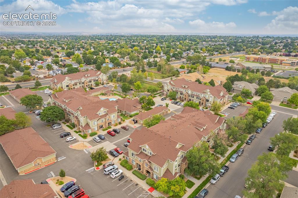 Image 26 of 27: Community setting with multiple multi-story residential buildings featuring