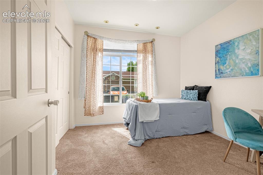 Image 7 of 27: Carpeted room featuring a window with grid detailing, recessed lighting, an