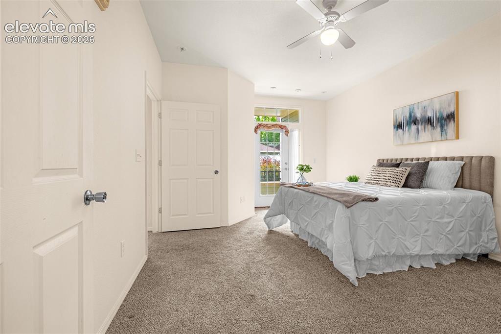 Image 8 of 27: Recessed lighting, ceiling fan, carpet flooring, patio access, and vaulted 