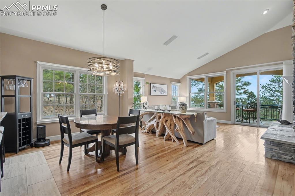 Image 12 of 45: The dining space sits beautifully under vaulted ceilings, making everyday m