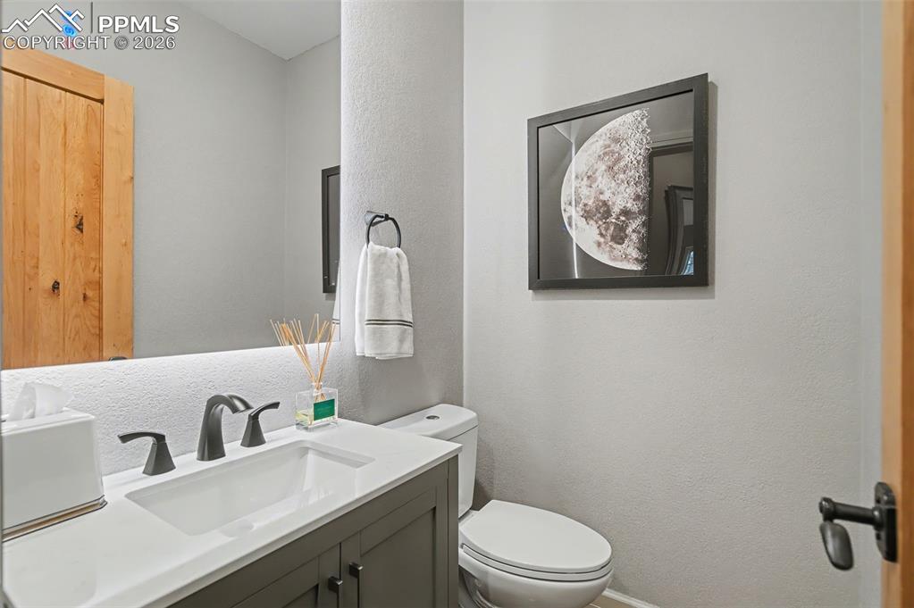 Image 27 of 45: Even the main-level powder room exudes luxury with its crisp, modern vanity