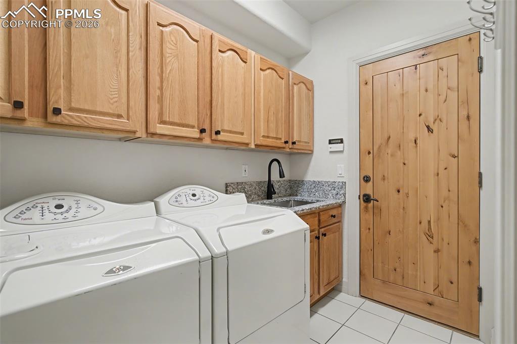 Image 28 of 45: The main-level laundry space, conveniently situated near the garage, elevat