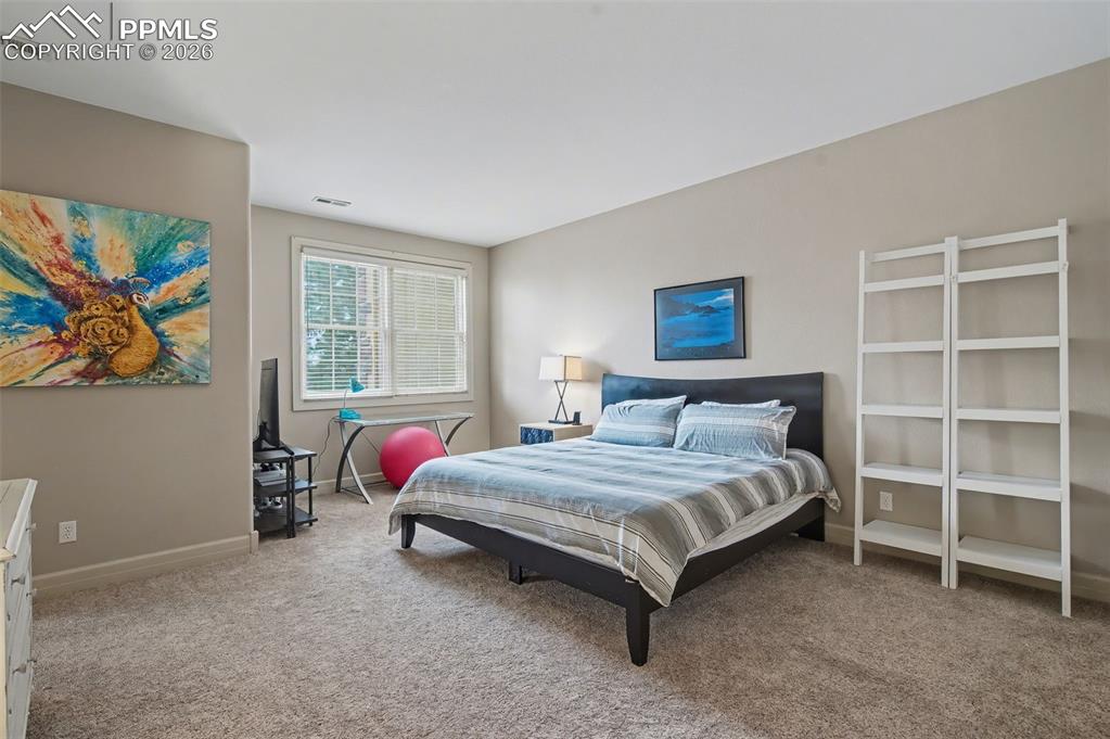 Image 29 of 45: Generous secondary bedrooms on the lower level ensure exceptional privacy a