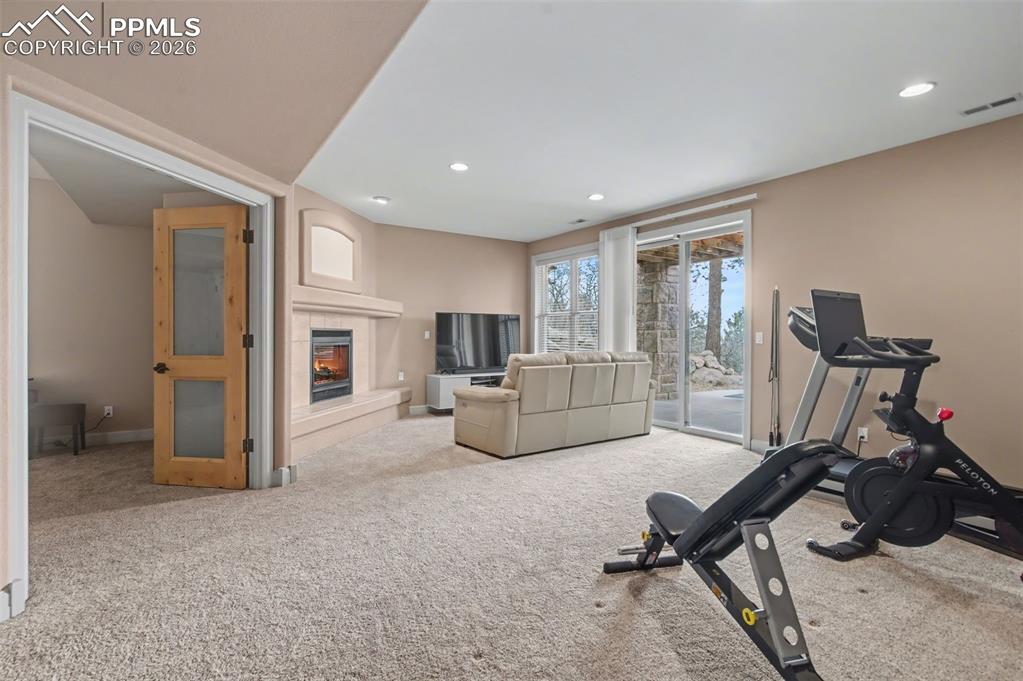 Image 34 of 45: The expansive lower-level family room provides a secondary entertainment hu