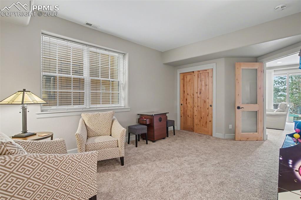 Image 36 of 45: This flexible lower-level nook is the ultimate blank canvas, perfect for an