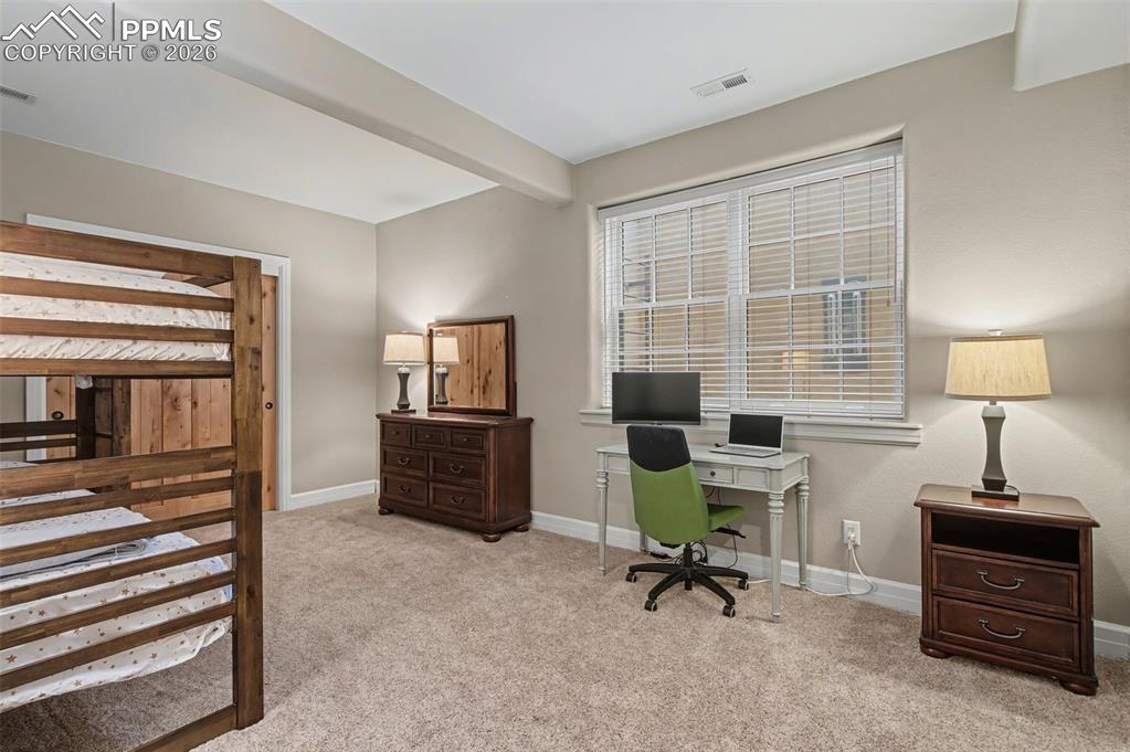 Image 39 of 45: A massive lower-level bedroom offers fantastic flexibility, easily accommod