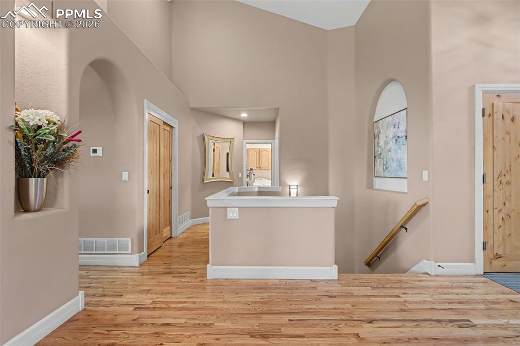 Image 4 of 45: Architectural arches and a bright, vaulted entryway promise effortless main