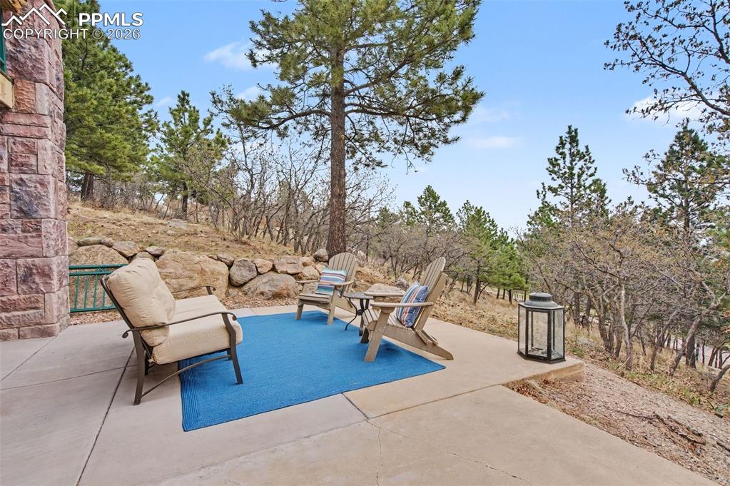 Image 40 of 45: The expanded lower-level patio, backing directly to nature, is perfectly pr