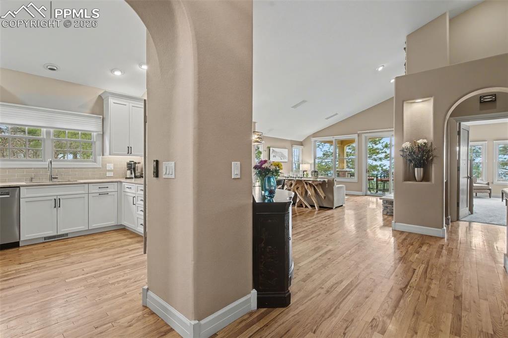 Image 5 of 45: Artful architectural curves gracefully transition you from the foyer into t