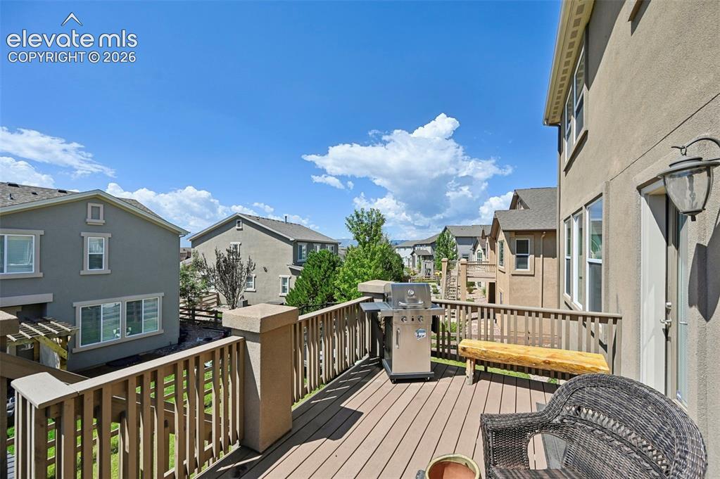 Image 14 of 50: Expansive outdoor deck with wood-finish decking and perimeter railing, feat