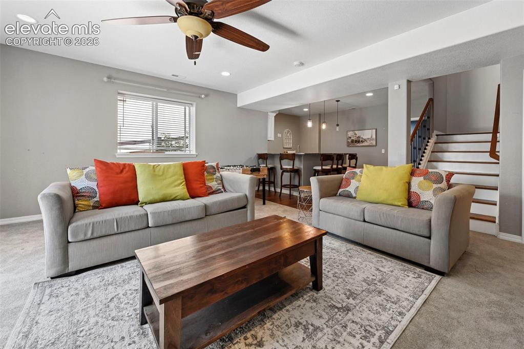 Image 22 of 50: Recessed lighting, wood-finish ceiling fan, wood-finish staircase, and buil