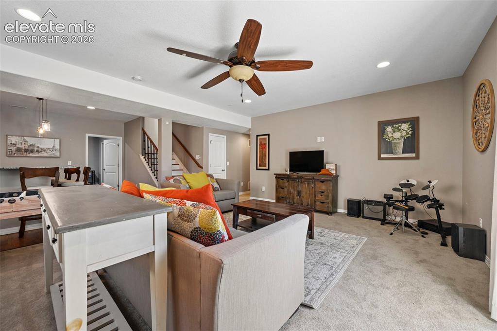 Image 23 of 50: Open-concept living space featuring a ceiling fan, recessed lighting, and c