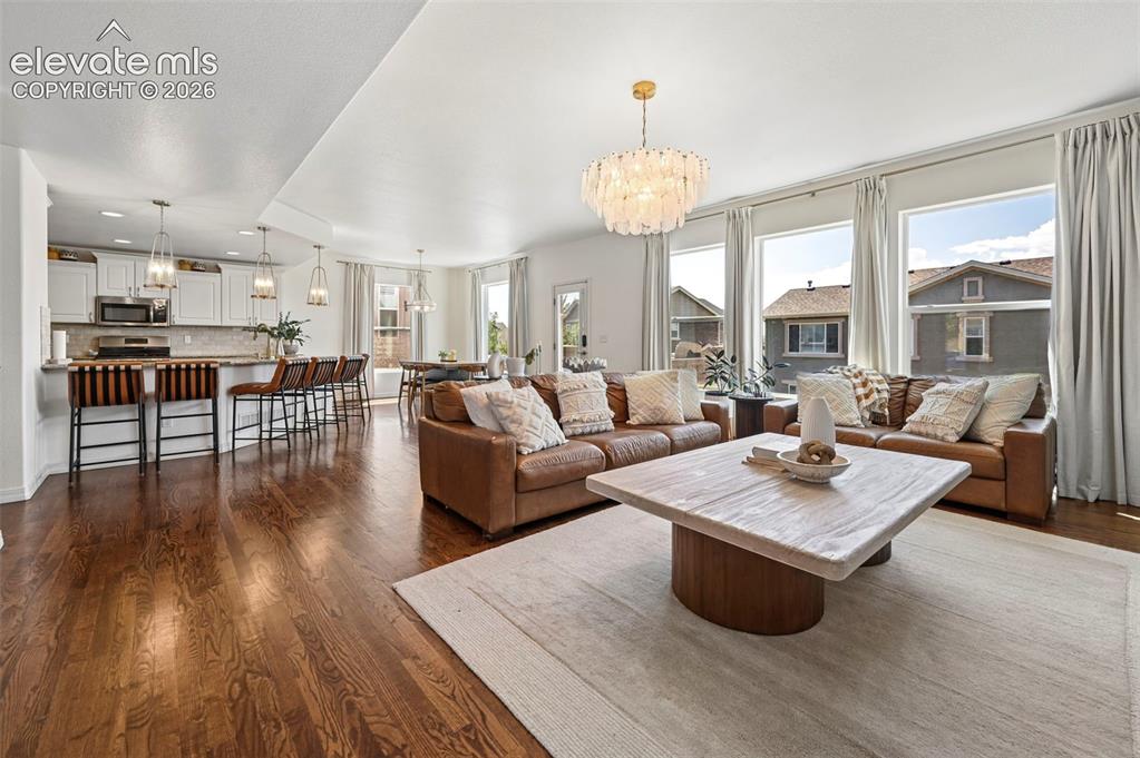 Image 4 of 50: Hardwood flooring, recessed lighting, white cabinetry, stainless steel appl