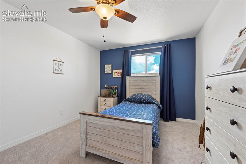 Image 41 of 50: Window with natural light, ceiling fan with integrated lighting, carpeted f
